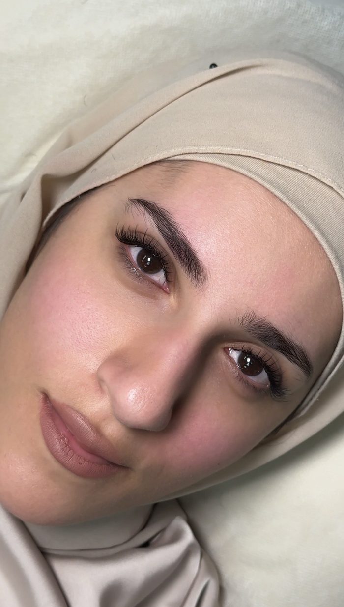 Client portrait showing eyelash extensions and brow work